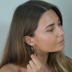 Angled Hoop Earrings with a softly sculpted organic silhouette, available in sterling silver, gold vermeil and rose gold vermeil.