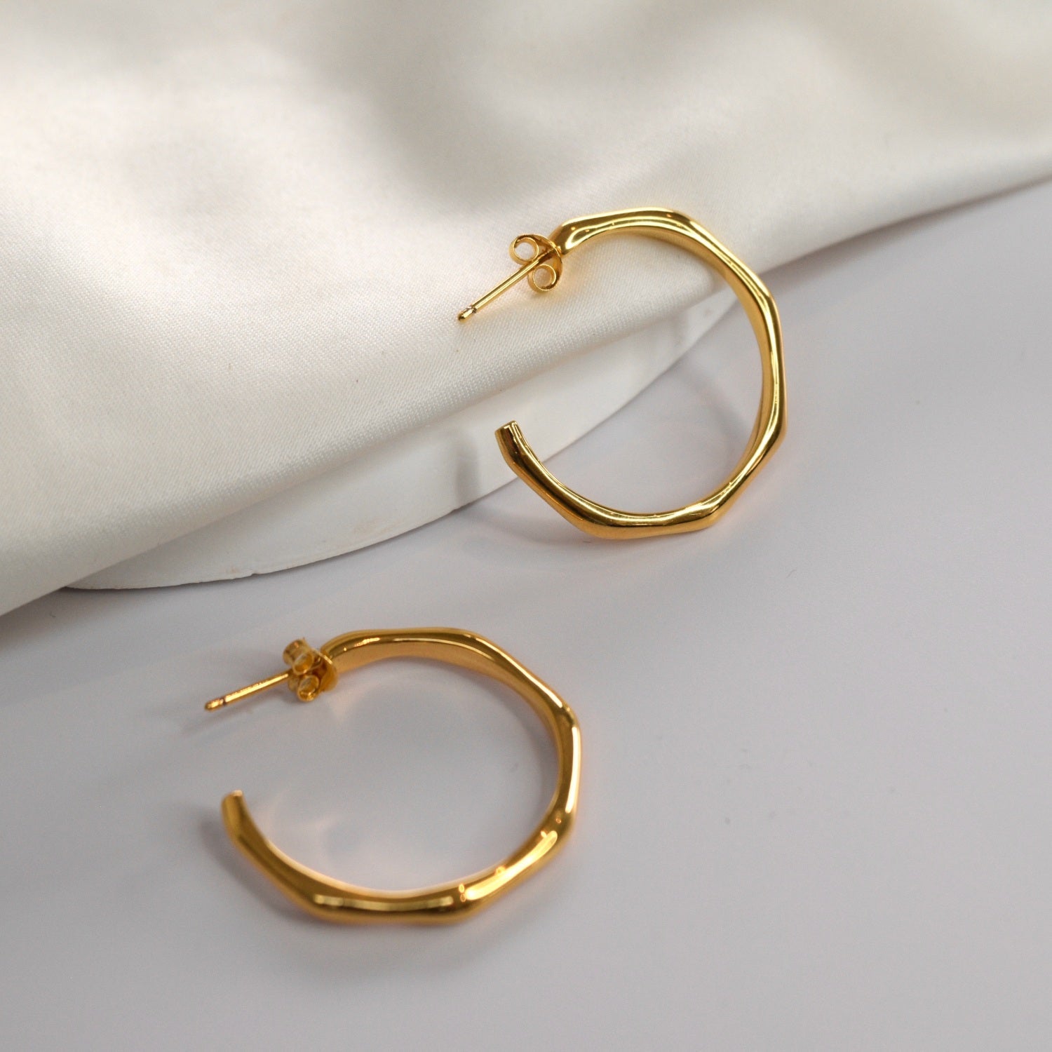 Angled Hoop Earrings with a softly sculpted organic silhouette, available in sterling silver, gold vermeil and rose gold vermeil.