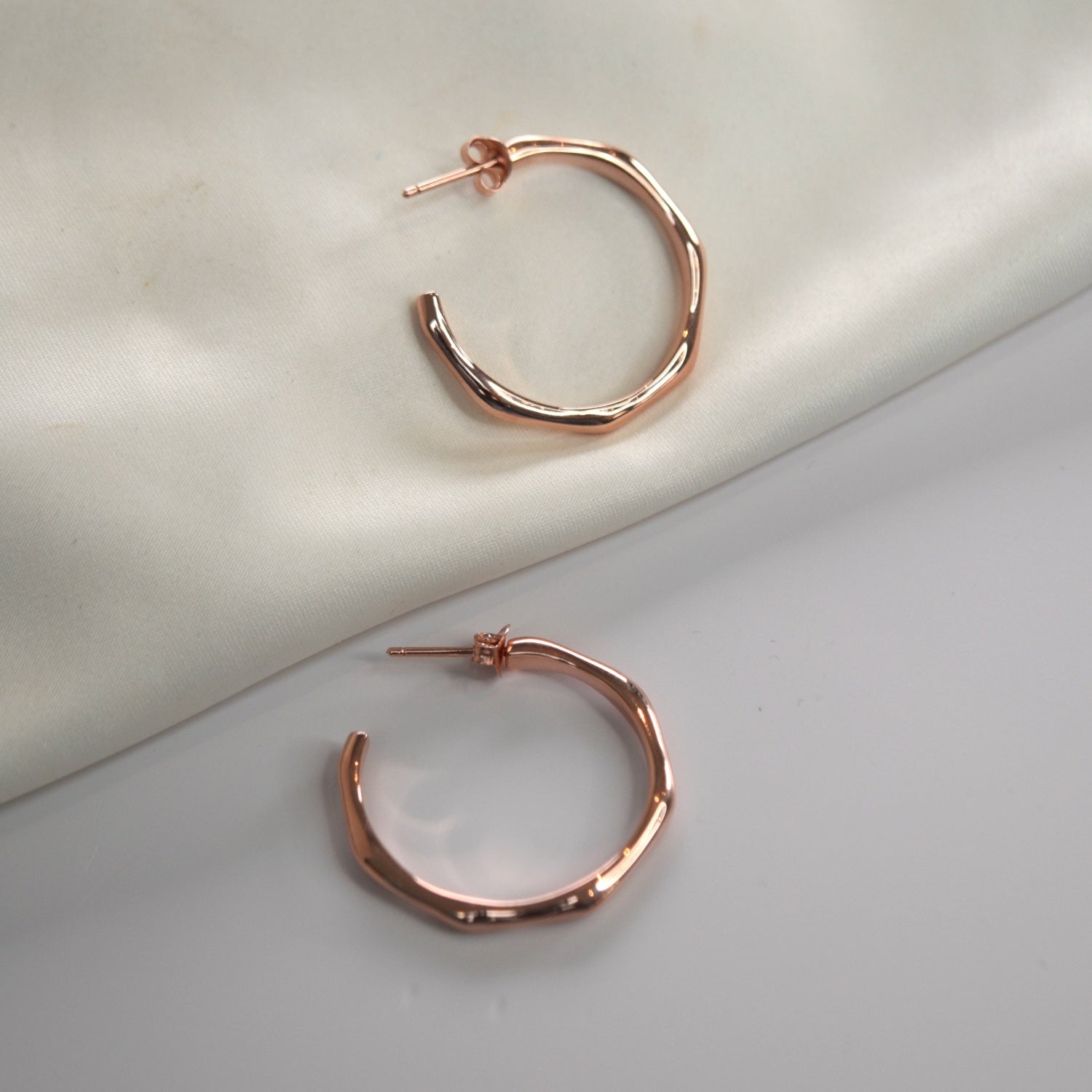 Angled Hoop Earrings with a softly sculpted organic silhouette, available in sterling silver, gold vermeil and rose gold vermeil.