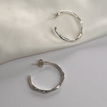 Angled Hoop Earrings with a softly sculpted organic silhouette, available in sterling silver, gold vermeil and rose gold vermeil.