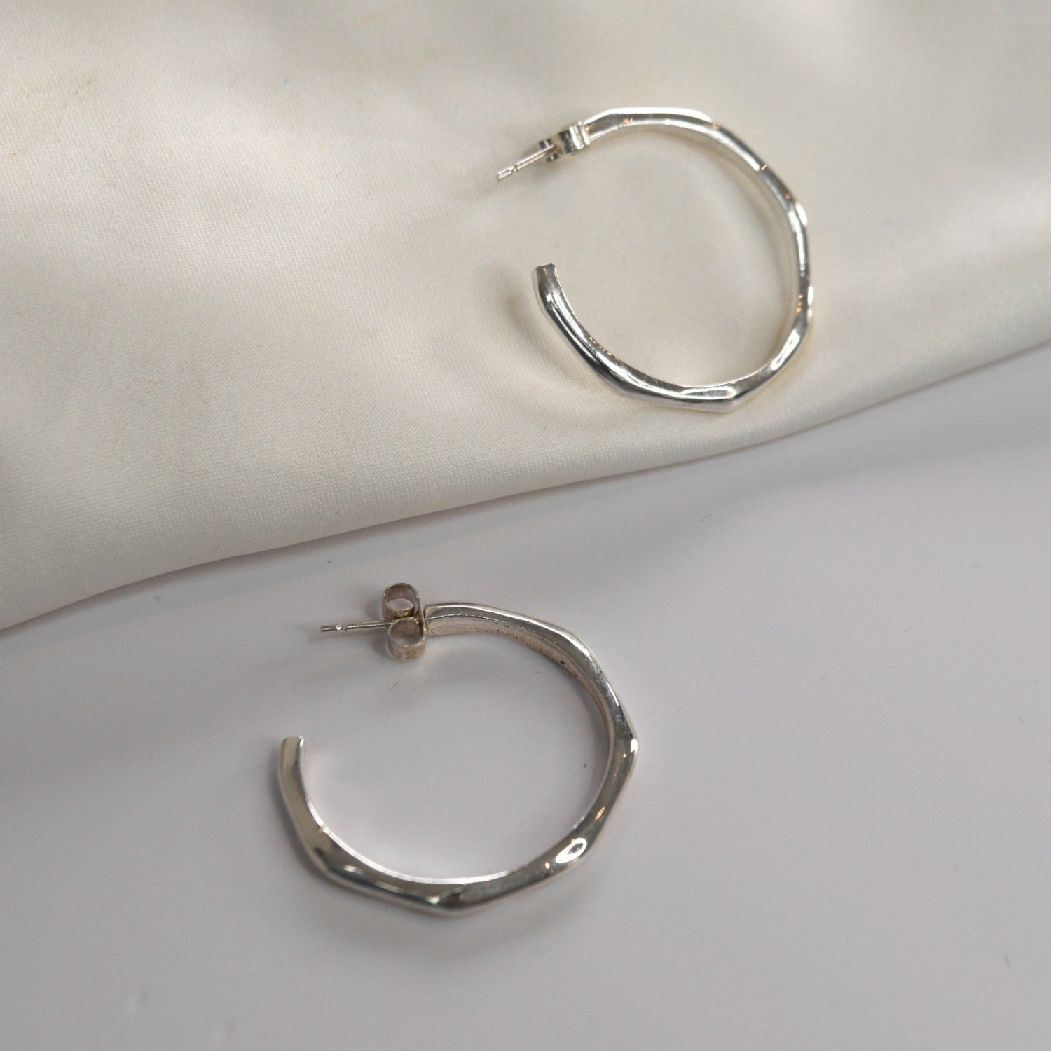 Angled Hoop Earrings with a softly sculpted organic silhouette, available in sterling silver, gold vermeil and rose gold vermeil.