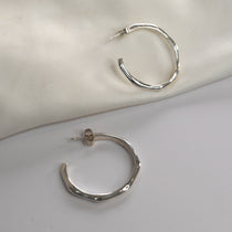 Angled Hoop Earrings with a softly sculpted organic silhouette, available in sterling silver, gold vermeil and rose gold vermeil.