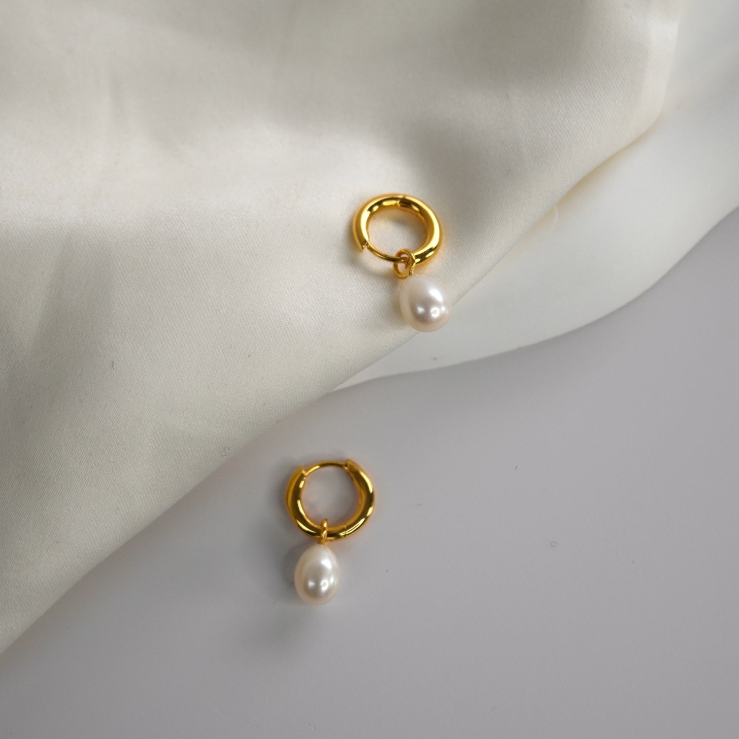 Freshwater Pearl Drop Huggie Earrings with removable cultured freshwater pearl drops.