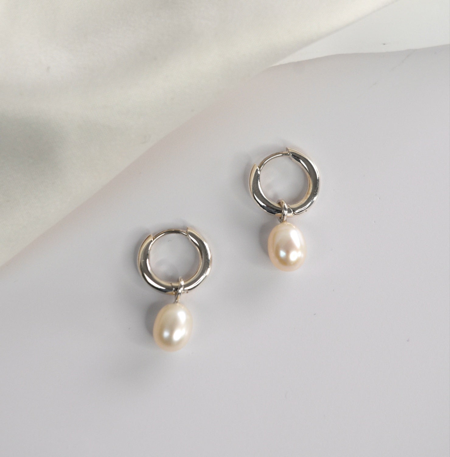 Freshwater Pearl Drop Huggie Earrings with removable cultured freshwater pearl drops.
