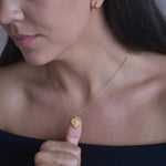 Gold Heart St Christopher Necklace shown on model with satellite chain detail 