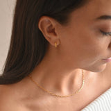 Gold vermeil paperclip chain necklace worn by a model in side profile, showing how the chain sits around the neck.