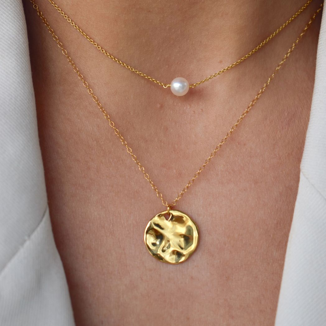 Layered gold vermeil necklaces with a freshwater pearl and hammered disc pendant