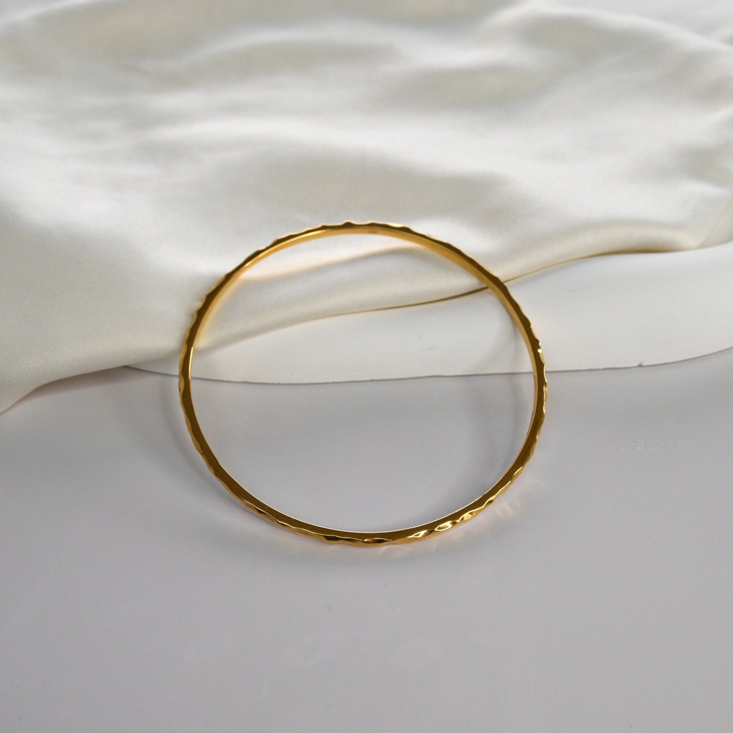 Hammered Bangle with an organic textured finish, available in sterling silver, gold vermeil and rose gold vermeil.