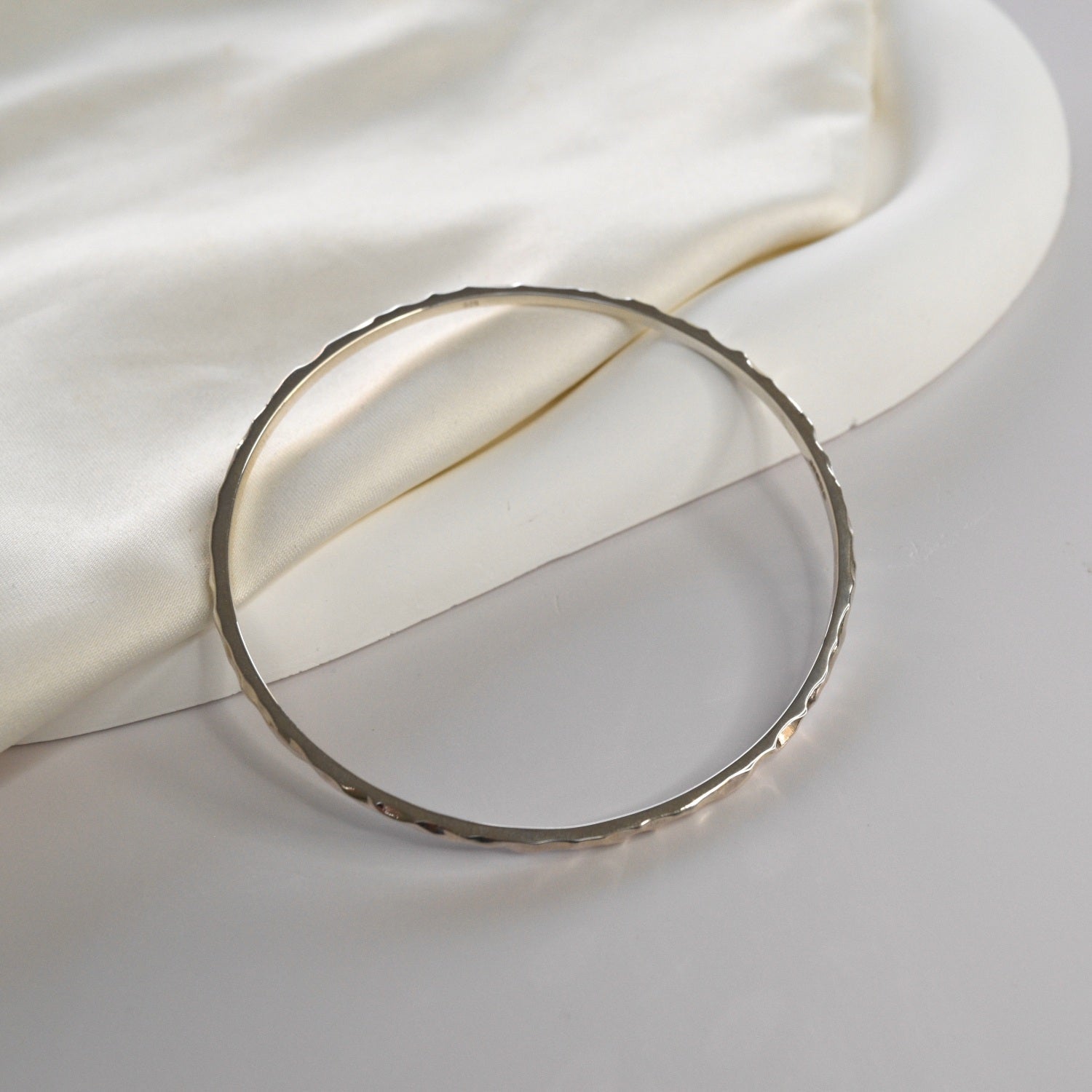 Hammered Bangle with an organic textured finish, available in sterling silver, gold vermeil and rose gold vermeil.