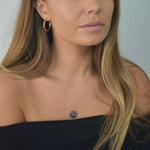 Hammered Disc Pendant Necklace with a textured circular pendant on a delicate chain.