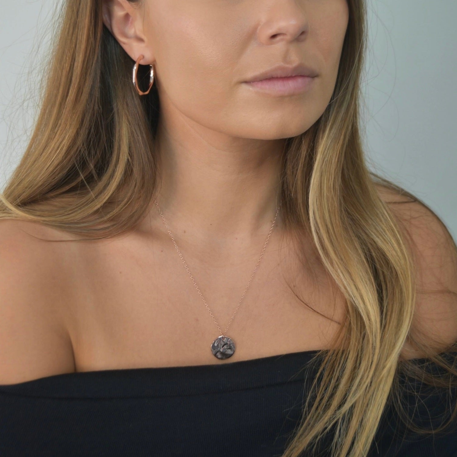 Hammered Disc Pendant Necklace with a textured circular pendant on a delicate chain.