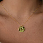 Hammered Disc Pendant Necklace with a textured circular pendant on a delicate chain.