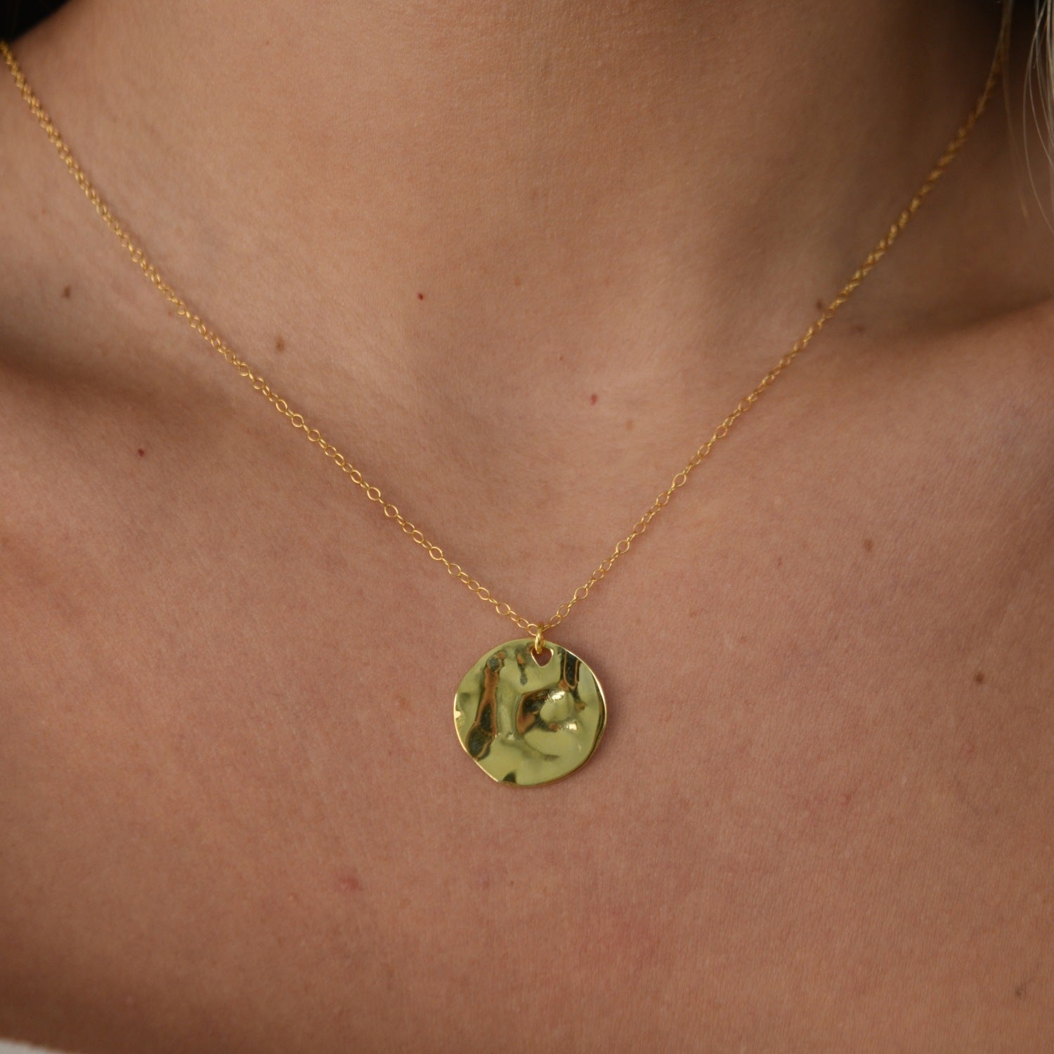 Hammered Disc Pendant Necklace with a textured circular pendant on a delicate chain.