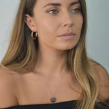 Hammered Disc Pendant Necklace with a textured circular pendant on a delicate chain.
