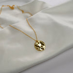 Hammered Disc Pendant Necklace with a textured circular pendant on a delicate chain.