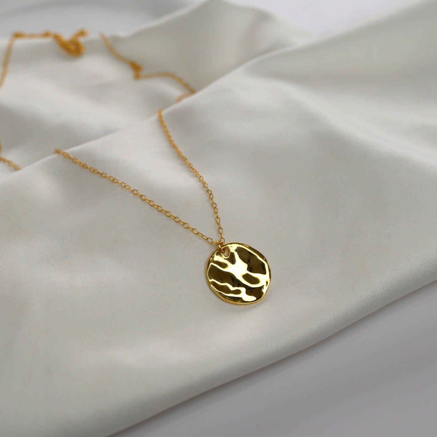 Hammered Disc Pendant Necklace with a textured circular pendant on a delicate chain.