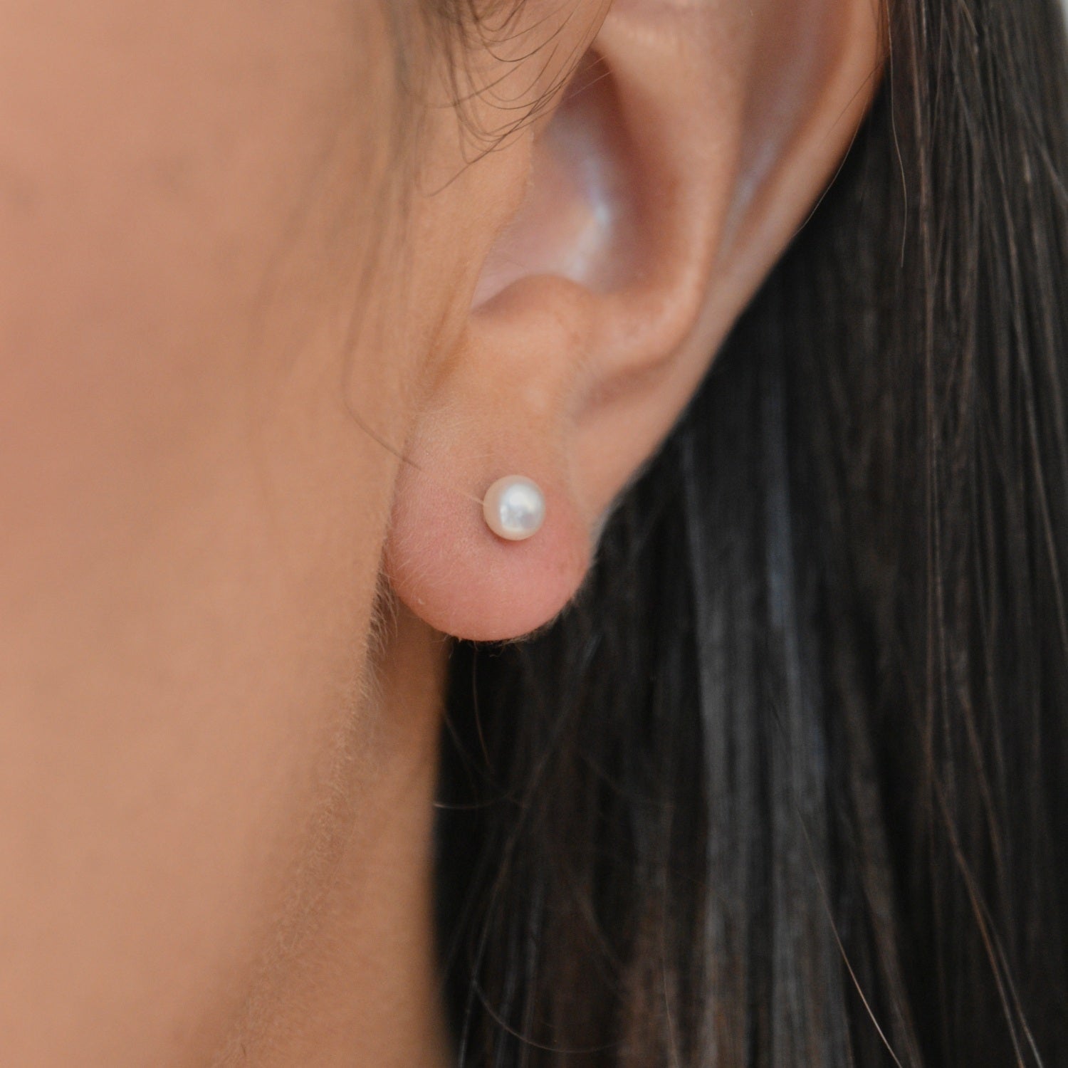Ivory Pearl Stud Earrings featuring cultured freshwater pearls set in sterling silver.