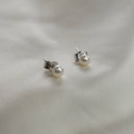 Ivory Pearl Stud Earrings featuring cultured freshwater pearls set in sterling silver.