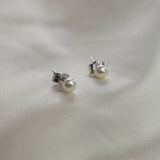 Ivory Pearl Stud Earrings featuring cultured freshwater pearls set in sterling silver.