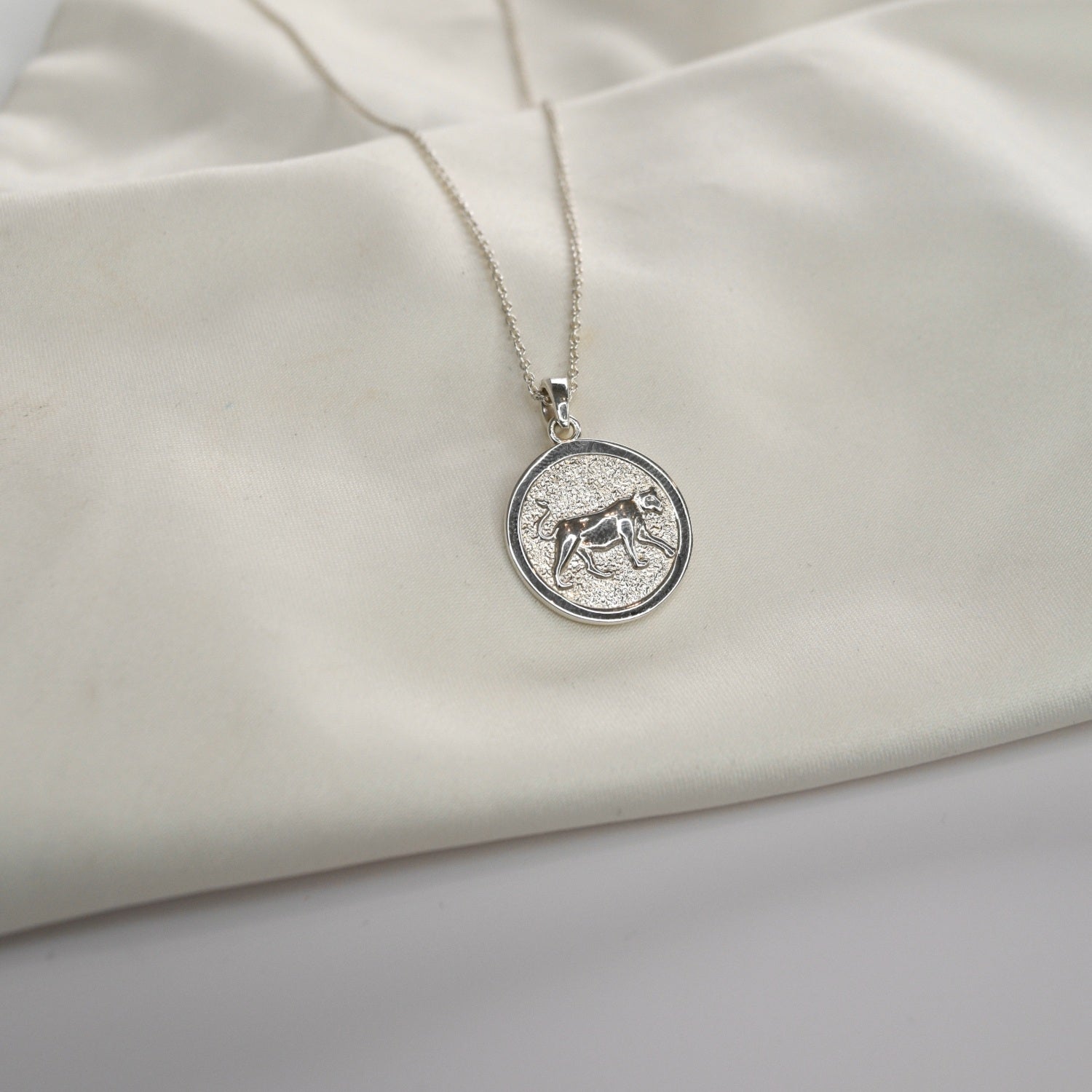 Lioness Pendant Necklace featuring a detailed lioness motif, available in gold vermeil and sterling silver.