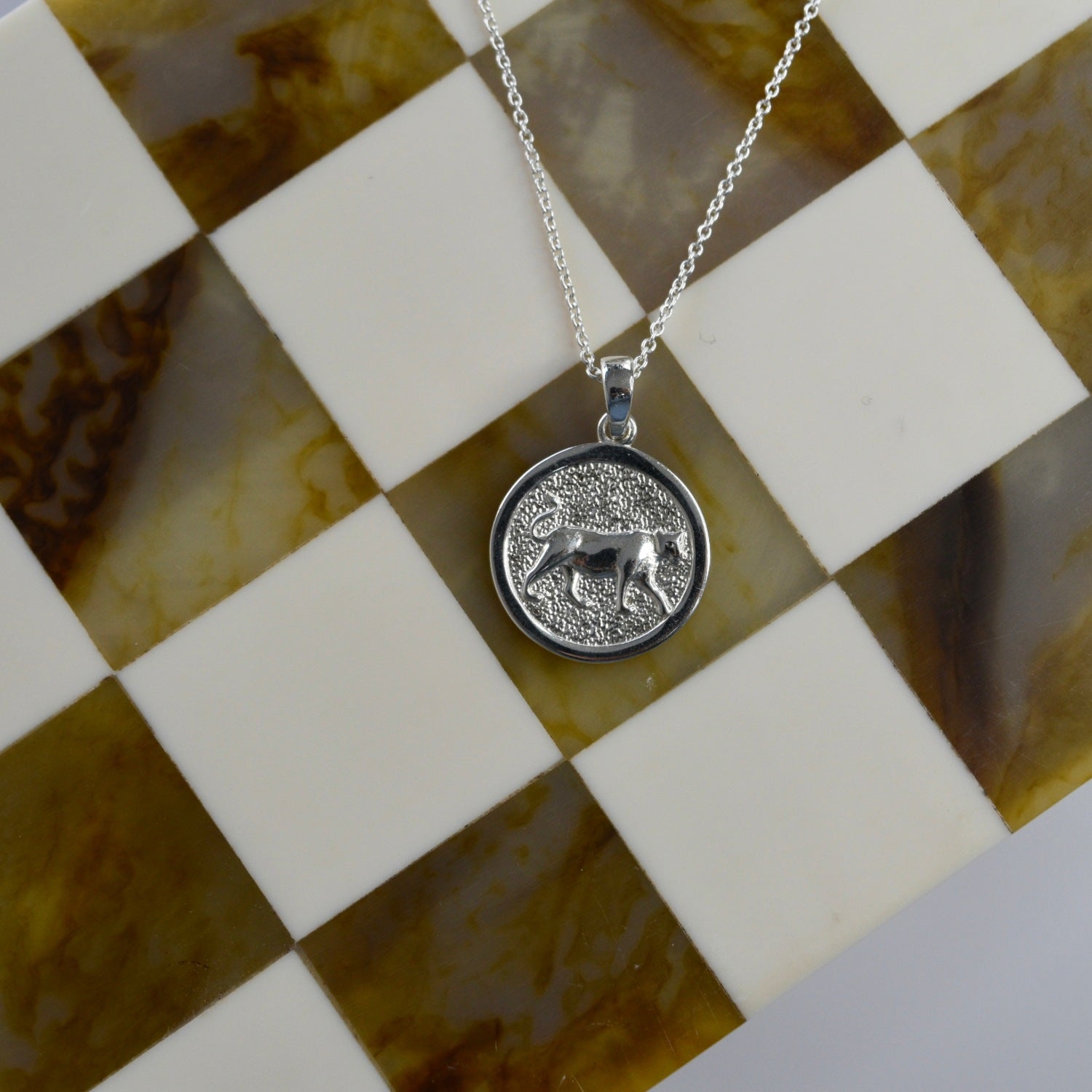 Lioness Pendant Necklace featuring a detailed lioness motif, available in gold vermeil and sterling silver.