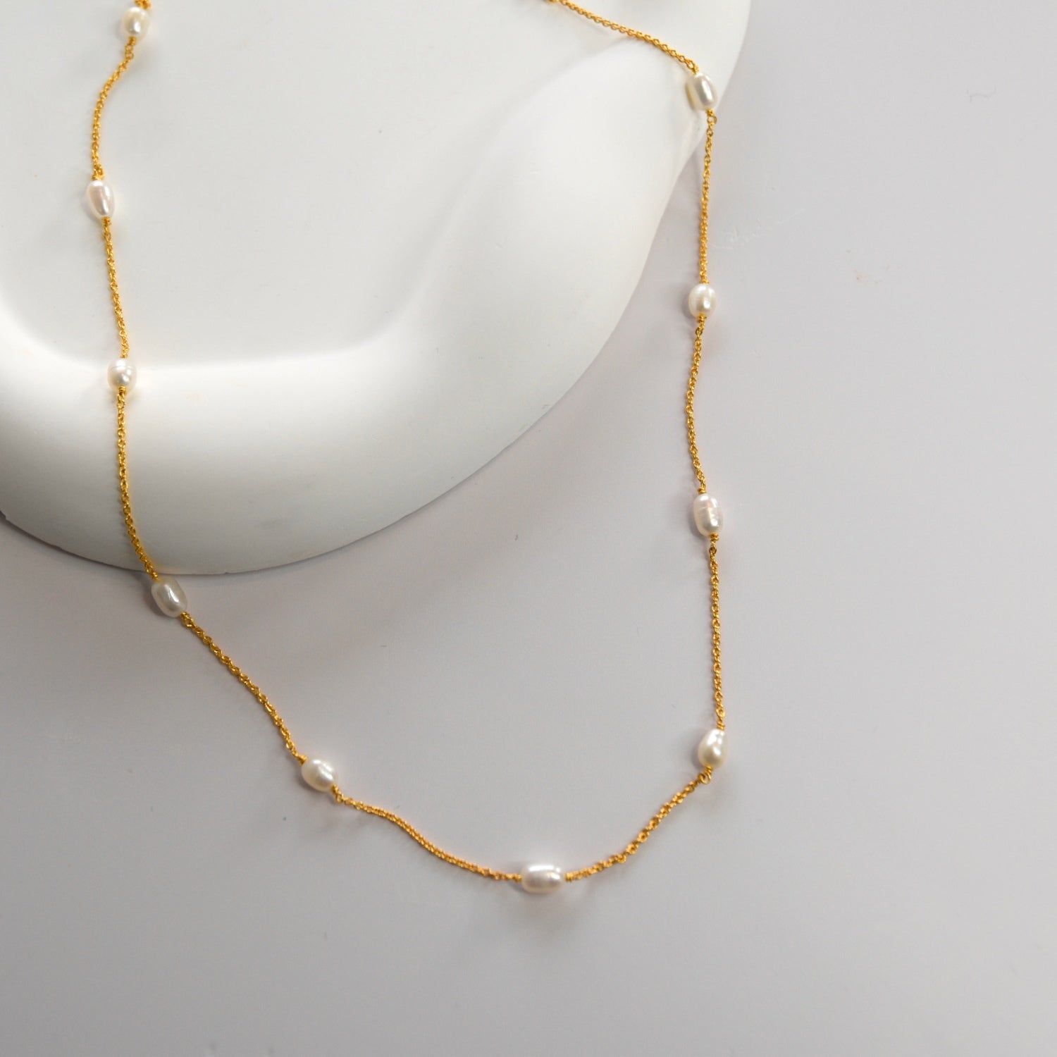 Nova Freshwater Ivory Pearl Necklace featuring lustrous freshwater pearls spaced along a delicate gold vermeil chain.