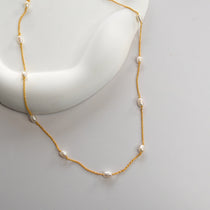 Nova Freshwater Ivory Pearl Necklace featuring lustrous freshwater pearls spaced along a delicate gold vermeil chain.