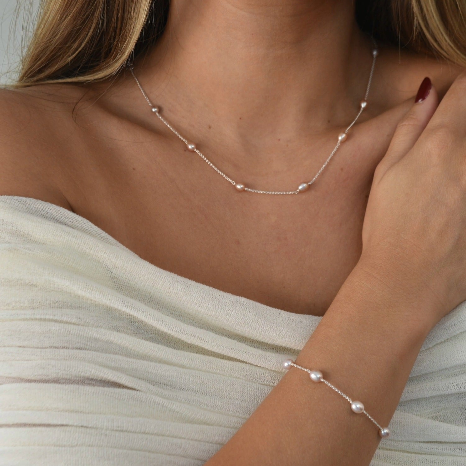 Nova Freshwater Pink Pearl Necklace featuring blush pink freshwater pearls spaced along a delicate sterling silver chain.