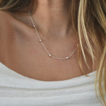 Nova Freshwater Pink Pearl Necklace featuring blush pink freshwater pearls spaced along a delicate sterling silver chain.