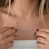 Nova Freshwater Pink Pearl Necklace featuring blush pink freshwater pearls spaced along a delicate sterling silver chain.