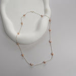 Nova Freshwater Pink Pearl Necklace featuring blush pink freshwater pearls spaced along a delicate sterling silver chain.