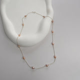 Nova Freshwater Pink Pearl Necklace featuring blush pink freshwater pearls spaced along a delicate sterling silver chain.
