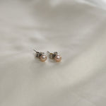 Pink Pearl Stud Earrings featuring cultured freshwater pearls set in sterling silver.