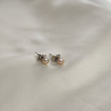 Pink Pearl Stud Earrings featuring cultured freshwater pearls set in sterling silver.