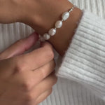 a model wearing a chunky pearl bead bracelet in silver