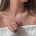 a model wearing a sterling silver st Christopher necklace on a plain trace chain 