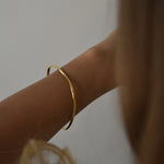 Signature Bangle with a softly sculpted organic silhouette, available in sterling silver, gold vermeil and rose gold vermeil.