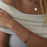Signature Bangle with a softly sculpted organic silhouette, available in sterling silver, gold vermeil and rose gold vermeil.