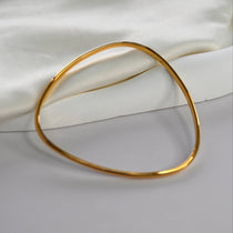 Signature Bangle with a softly sculpted organic silhouette, available in sterling silver, gold vermeil and rose gold vermeil.