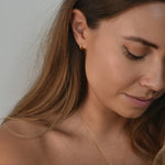 Signature Huggie Earrings with a polished finish, available in sterling silver or 18ct gold vermeil.