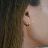 Signature Huggie Earrings with a polished finish, available in sterling silver or 18ct gold vermeil.