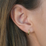 Signature Huggie Earrings with a polished finish, available in sterling silver or 18ct gold vermeil.