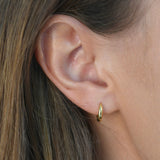 Signature Huggie Earrings with a polished finish, available in sterling silver or 18ct gold vermeil.