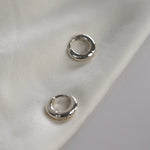 Signature Huggie Earrings with a polished finish, available in sterling silver or 18ct gold vermeil.