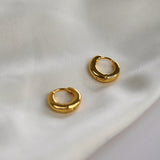 Signature Huggie Earrings with a polished finish, available in sterling silver or 18ct gold vermeil.