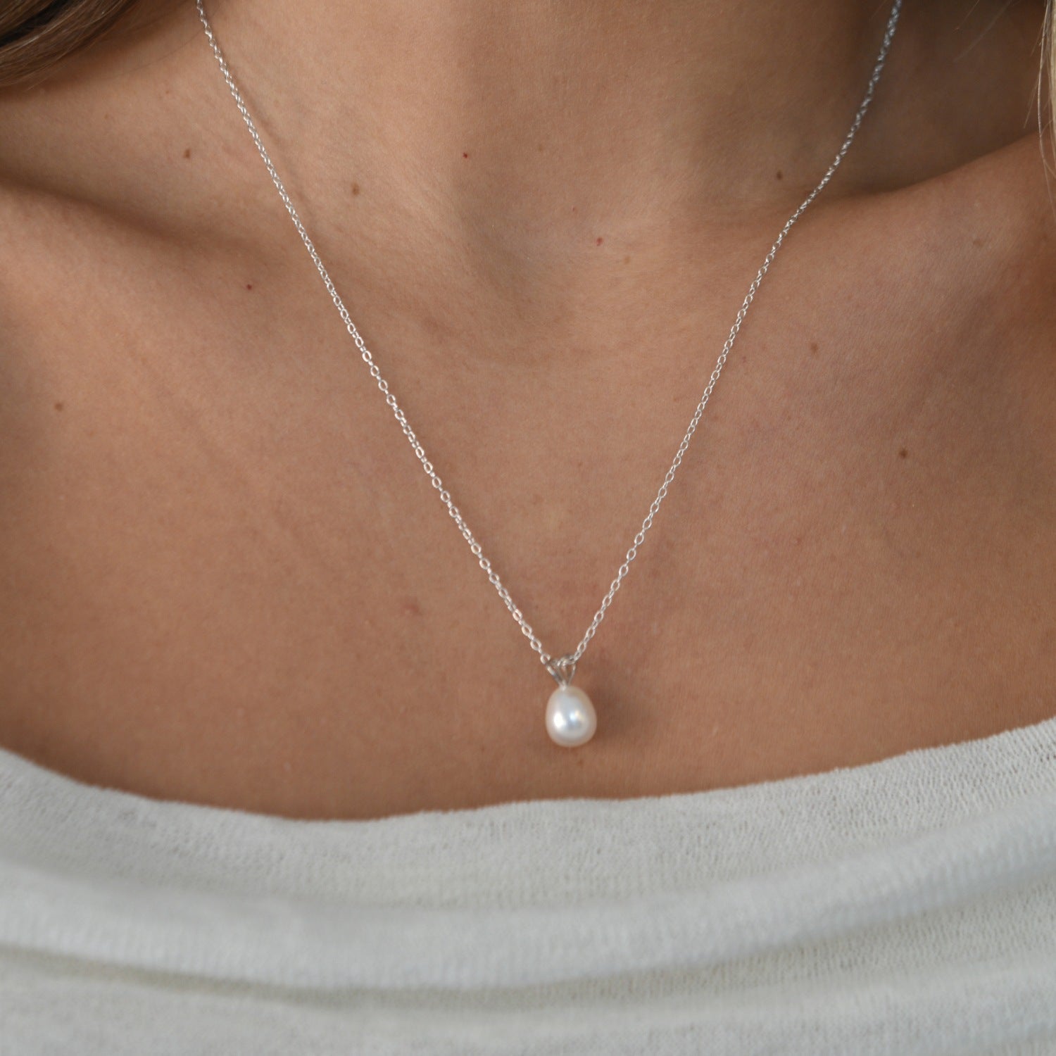 White Gold Drop Pearl Necklace with a lustrous freshwater pearl pendant on a delicate sterling silver chain.