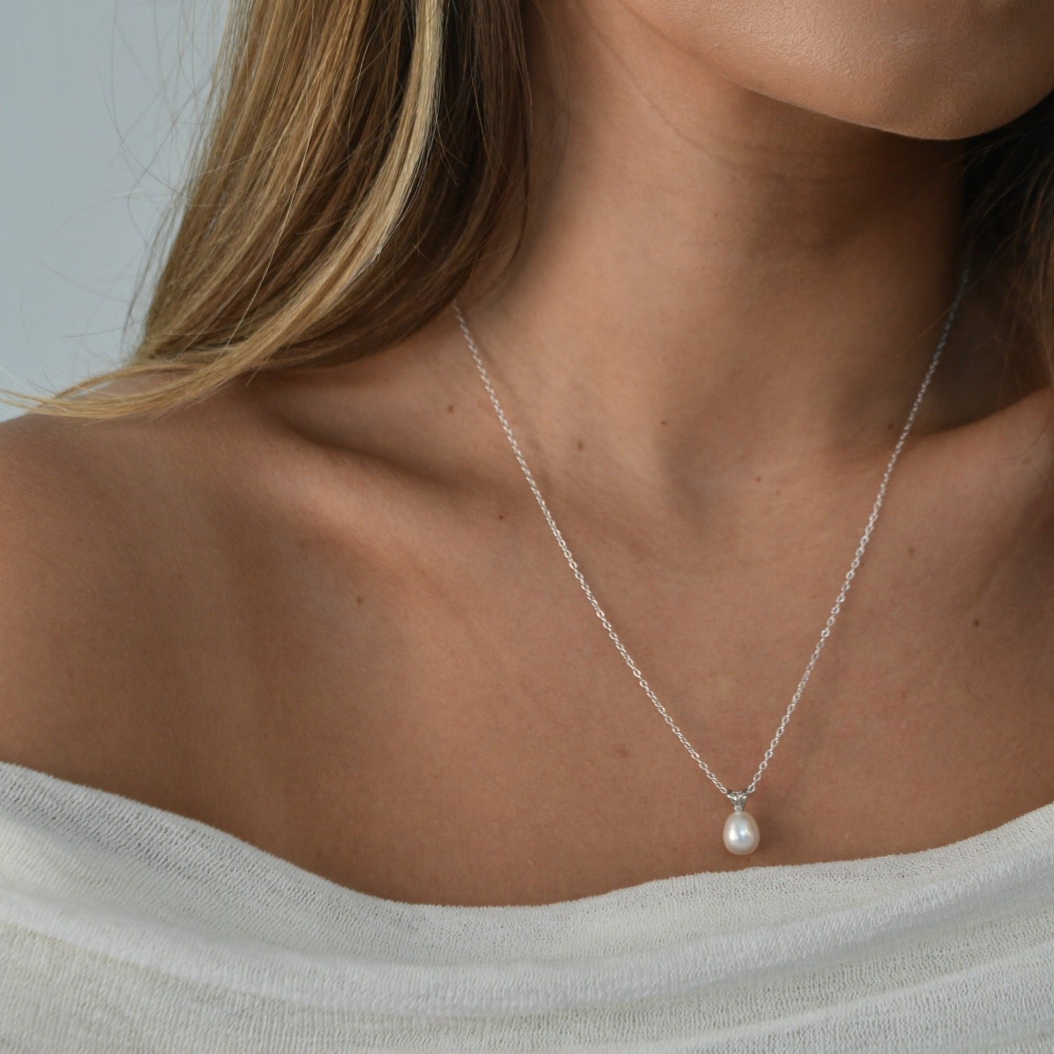 White Gold Drop Pearl Necklace with a lustrous freshwater pearl pendant on a delicate sterling silver chain.