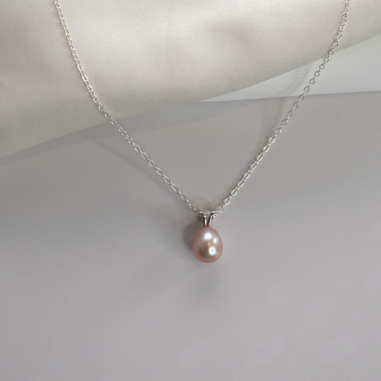 White Gold Drop Pearl Necklace with a lustrous freshwater pearl pendant on a delicate sterling silver chain.