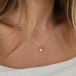 White Gold Drop Pearl Necklace with a lustrous freshwater pearl pendant on a delicate sterling silver chain.