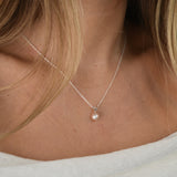 White Gold Drop Pearl Necklace with a lustrous freshwater pearl pendant on a delicate sterling silver chain.